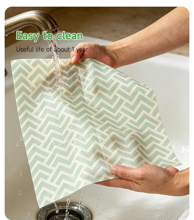 Mint green chevron reusable beeswax food wrap being rinsed under running water