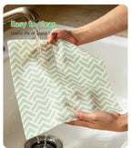 Mint green chevron reusable beeswax food wrap being rinsed under running water