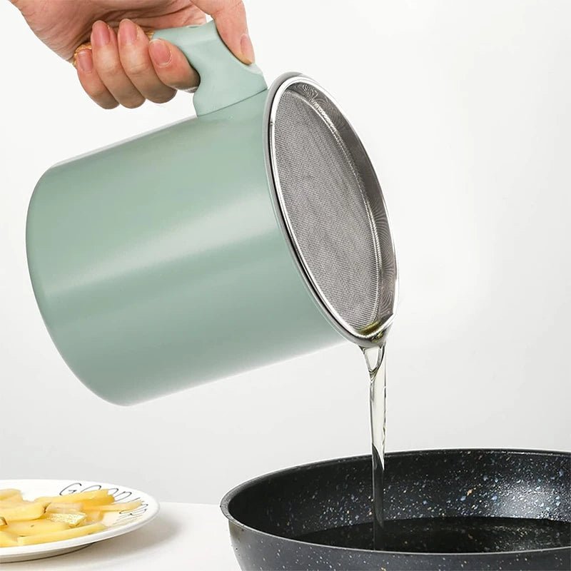 Light green grease container tilted to pour; fine stainless mesh strainer on top
