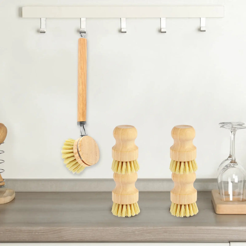 Wood-handled dish scrub brushes with round heads hanging on wall hooks