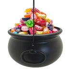 Black cauldron candy bucket packed with colorful wrapped candies, hanging hook