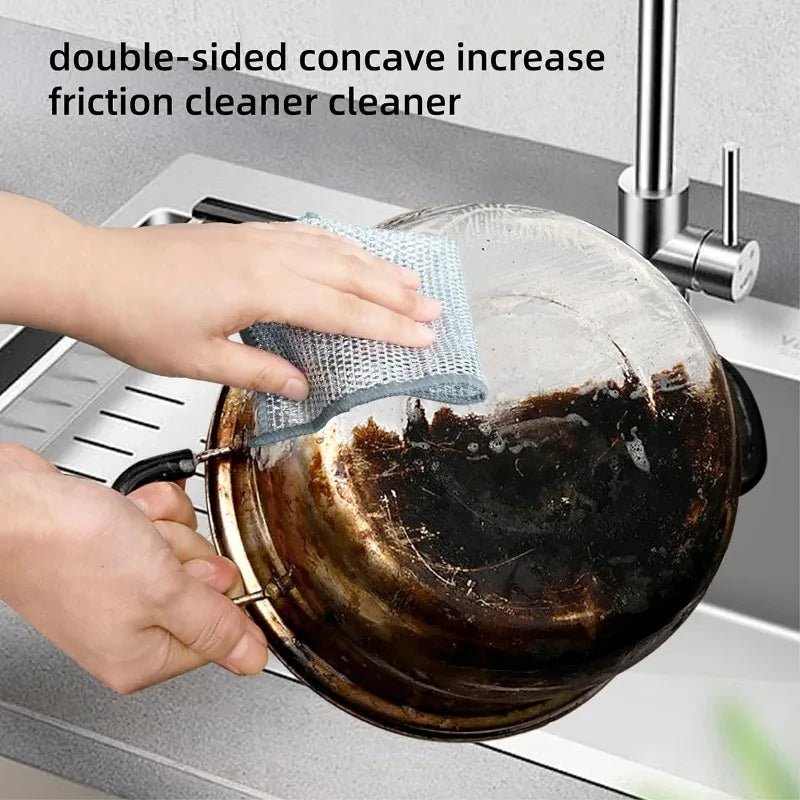Non-scratch steel wire cleaning cloth in hands, scrubbing a pan on a counter