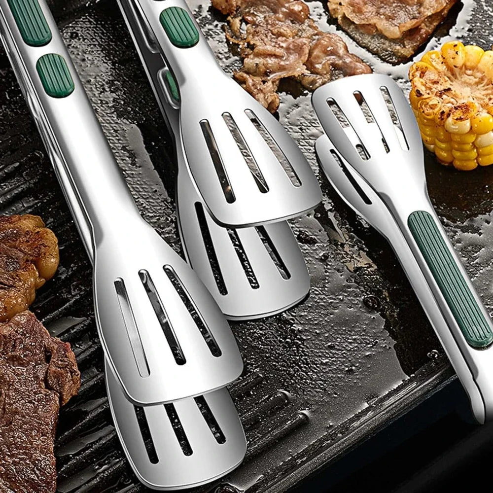Stainless steel grilling tongs with slotted spatula tips, green silicone handle grips