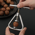 Stainless steel manual nutcracker and sheller with U-shaped frame and screw press
