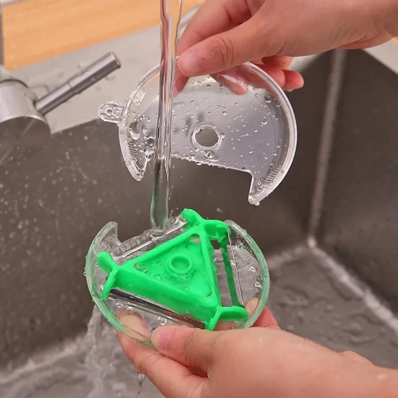 3-in-1 rotary vegetable peeler rinsed under water with green blade insert