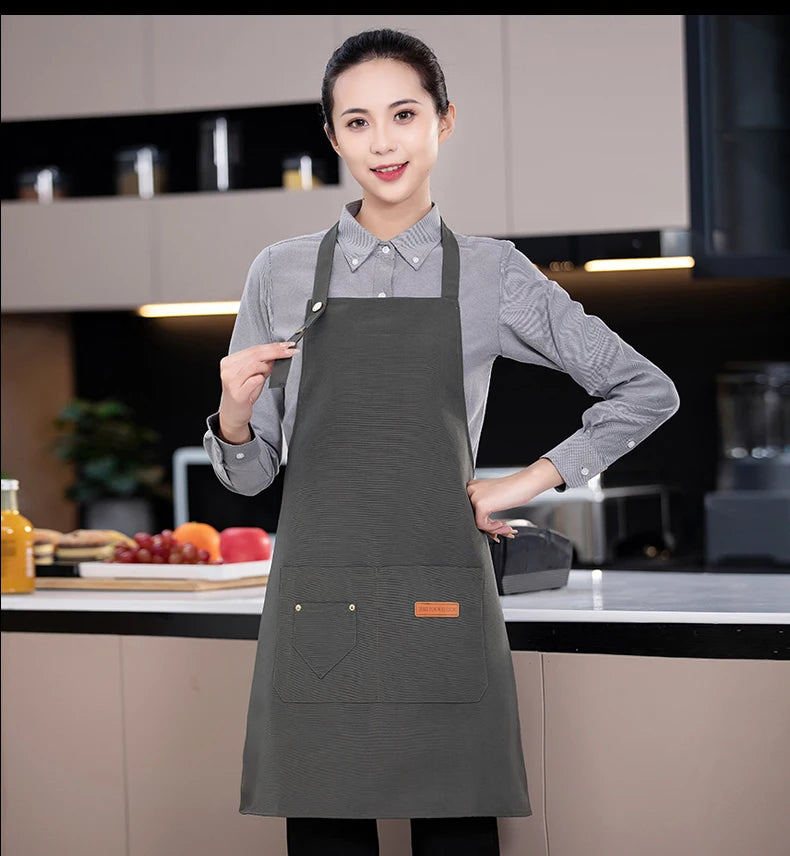 Gray canvas chef apron with adjustable neck strap and large front pocket