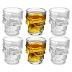 Six skull head shot glasses arranged in two rows: clear and golden amber