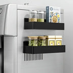 Black magnetic refrigerator storage basket with hooks mounted on white fridge