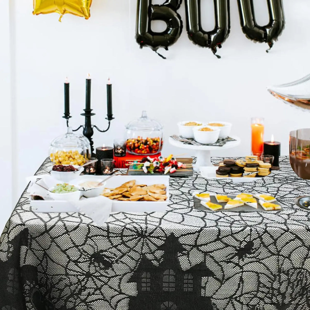 Black spider web lace table runner on dining table with scalloped border