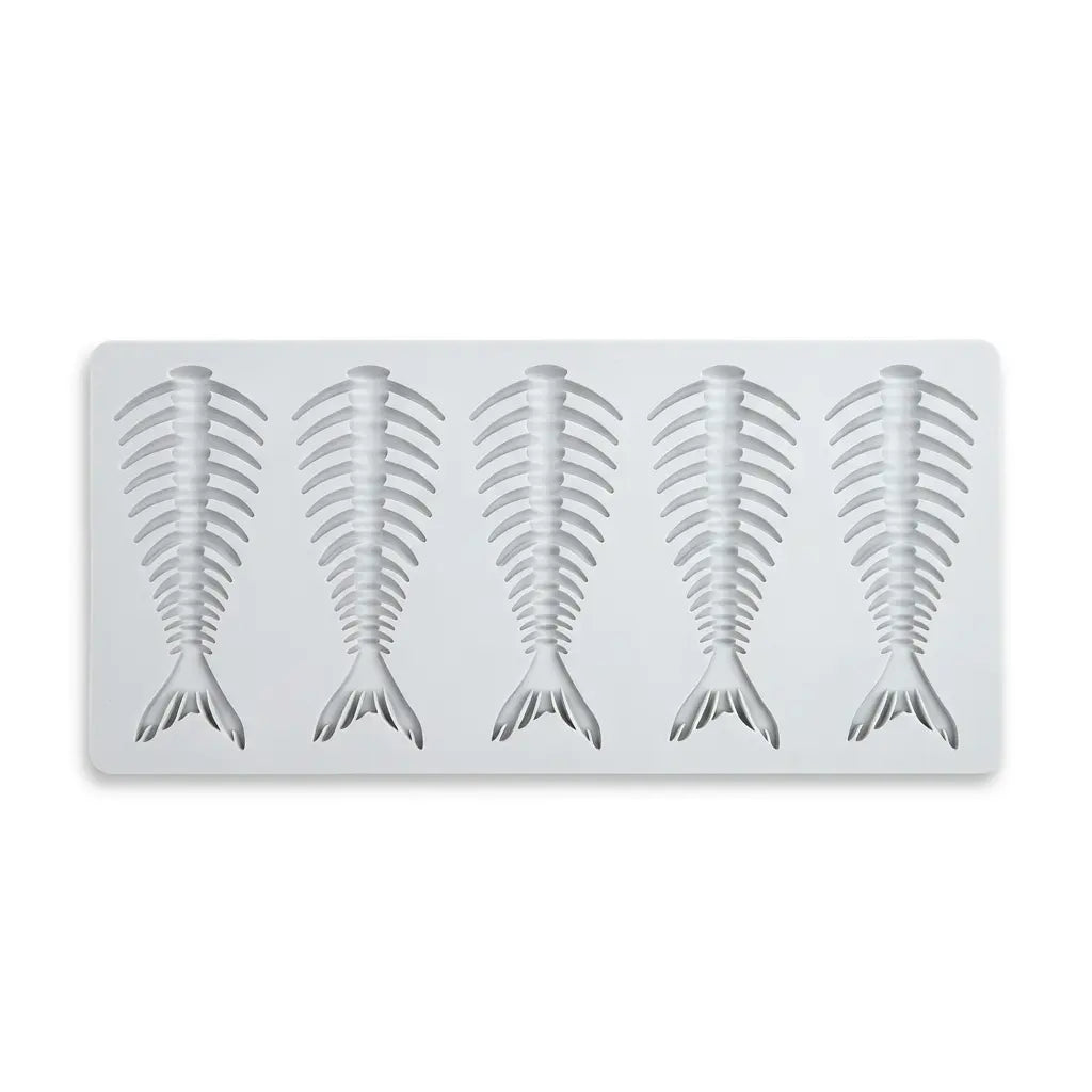 Gray silicone mold with four fish skeleton fishbone shapes on white background.