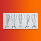 Gray silicone mold with four fish skeleton fishbone shapes on orange-red gradient background.