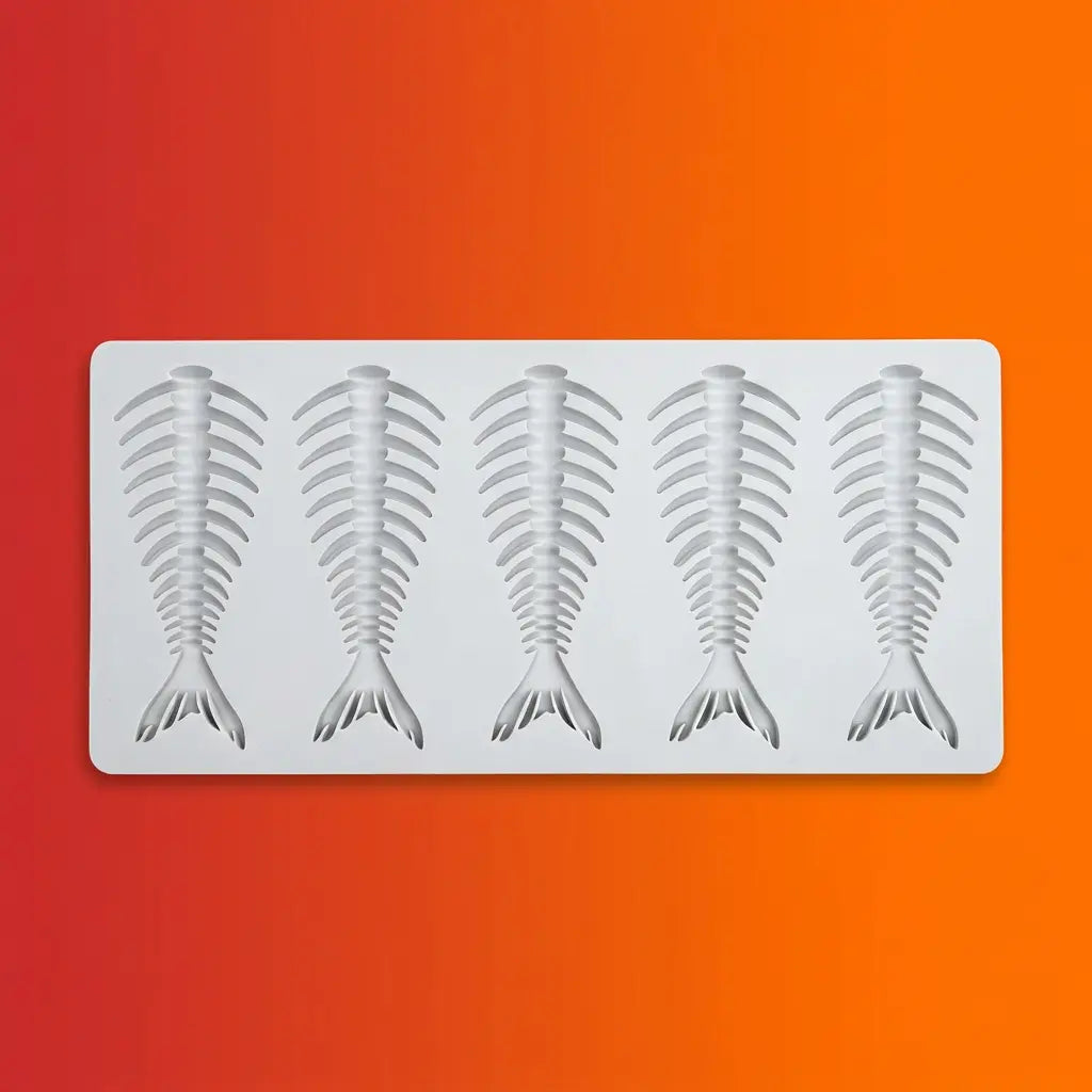 Gray silicone mold with four fish skeleton fishbone shapes on orange-red gradient background.