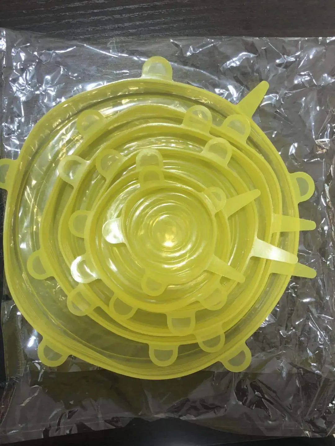 Reusable silicone stretch lids set in lemon yellow, circular lids with pull tabs