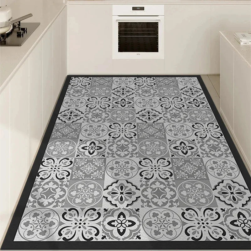 PVC kitchen floor mat with gray-and-white floral damask pattern and black border.