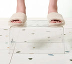 Clear plastic organizer bin being carried, featuring built-in side handles