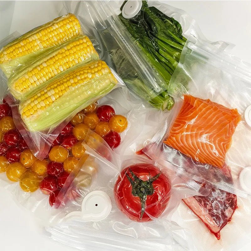 Vacuum sealer food storage bags with valves, filled with sealed meats and vegetables