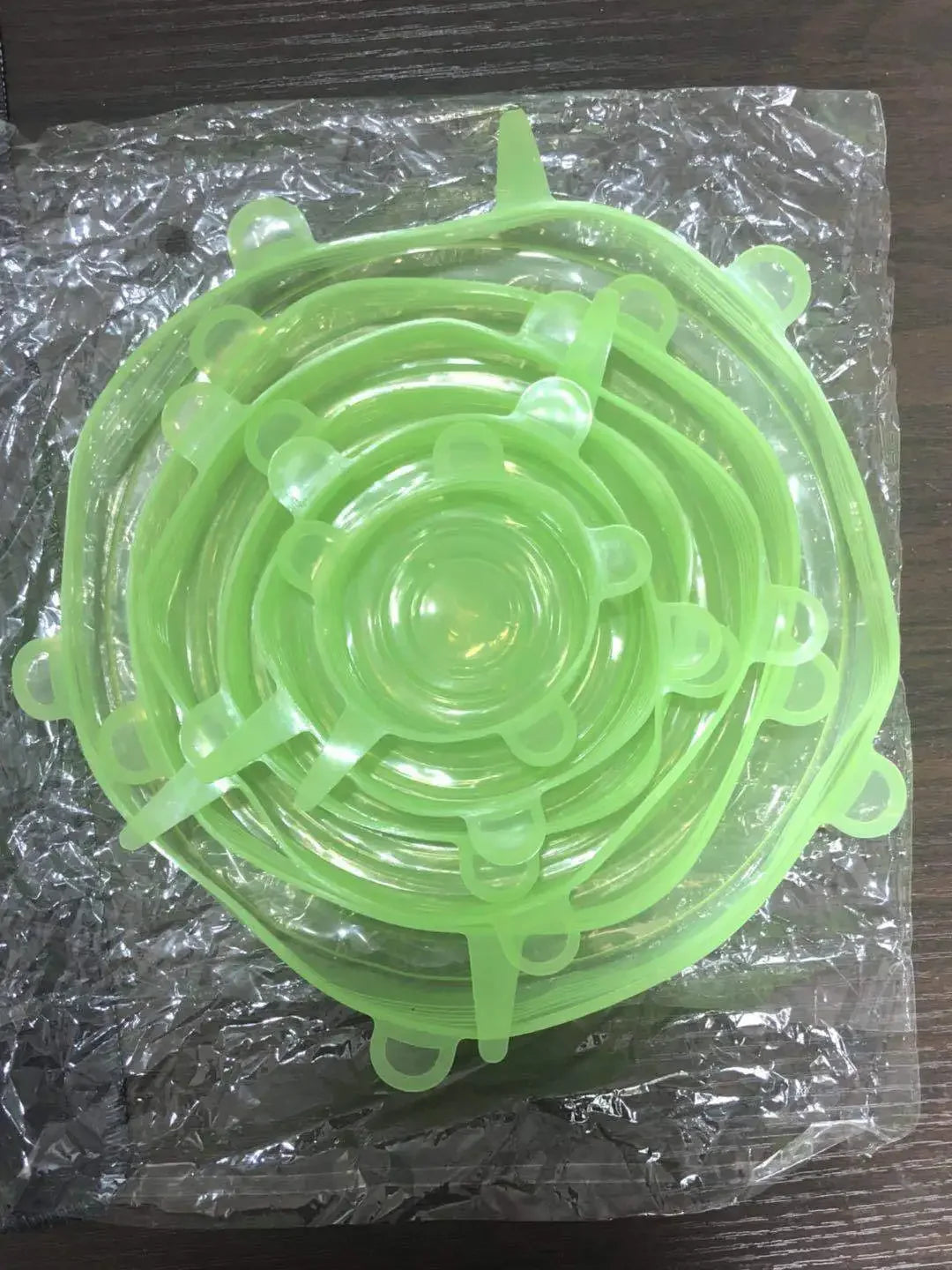 Reusable silicone stretch lids set in mint green, stackable circular lids with pull tabs