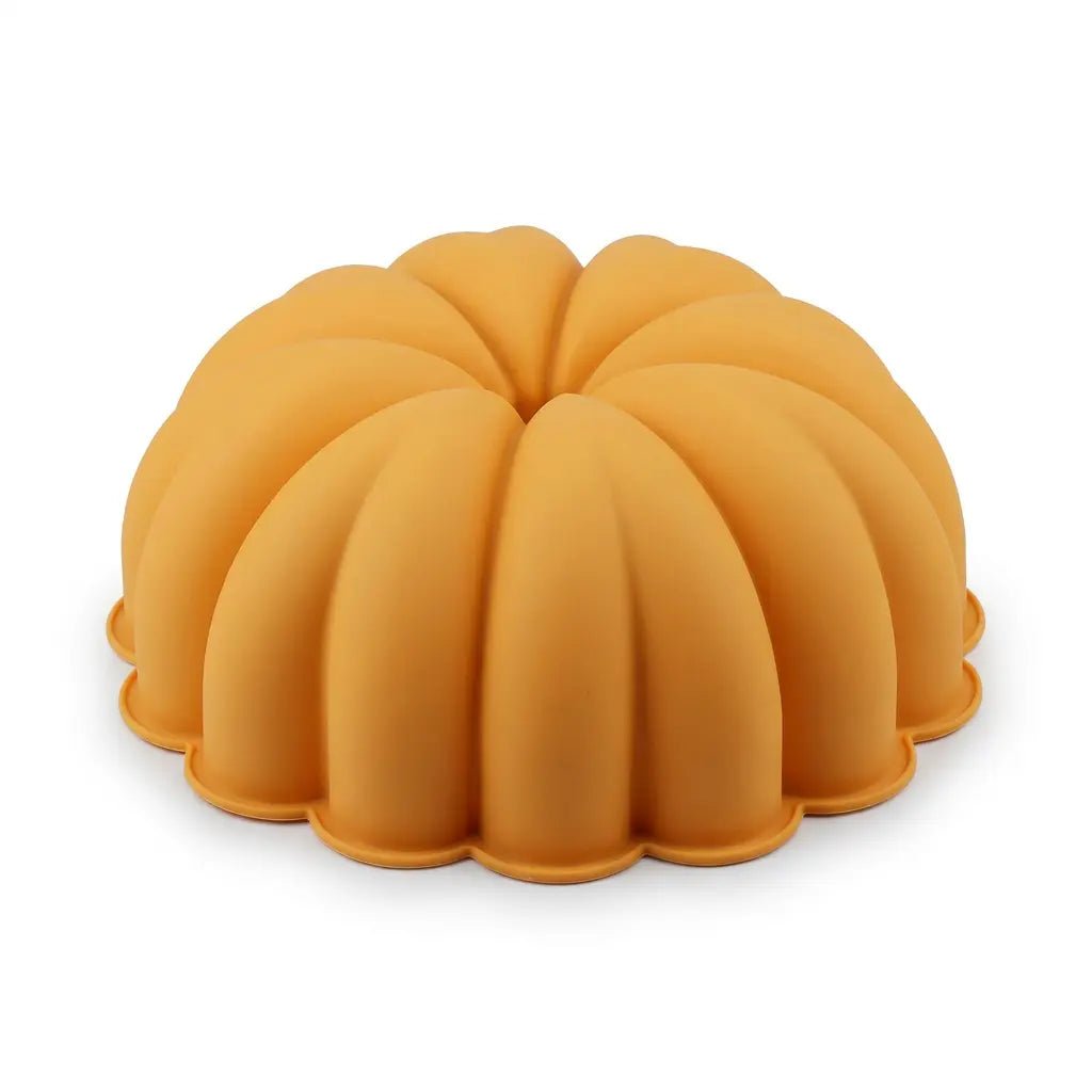 Orange pumpkin-shaped silicone bundt cake or jello mold on white background.
