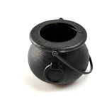 Black cast iron Halloween witch cauldron with a metal handle on white background.