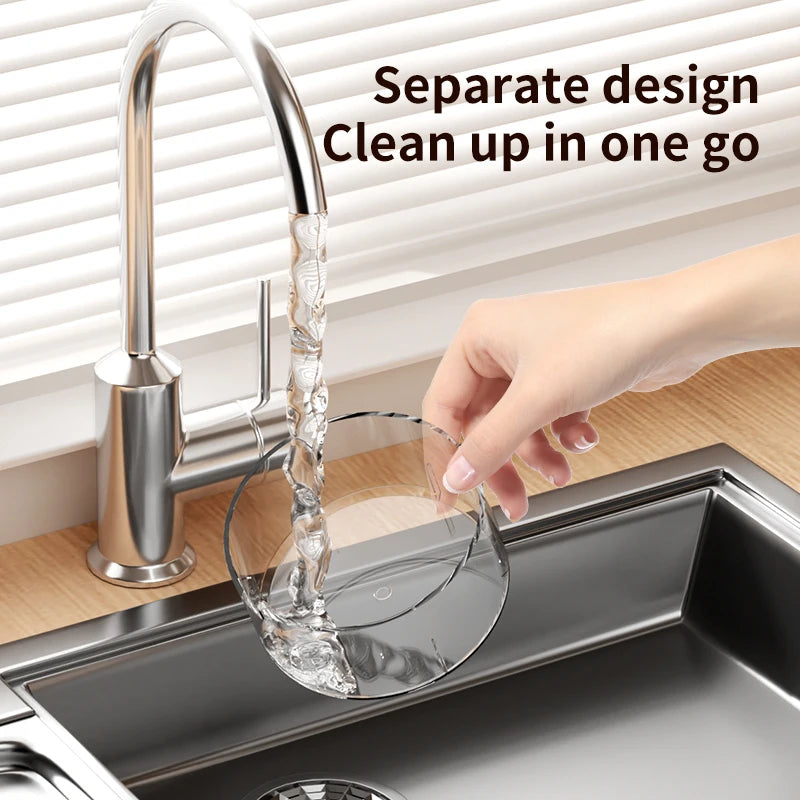 White multi-hole cherry pitter being rinsed in sink; clear collection chamber visible