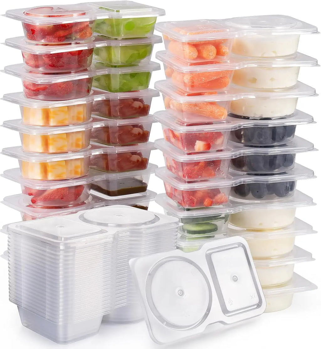 Reusable double-compartment snack containers with clear lids, stacked set with assorted contents