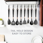 Black silicone cooking utensils with rose-gold tips on hanging storage rail