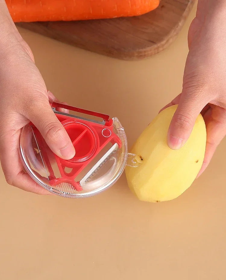 Red rotary vegetable peeler with stainless steel blades, peeling a potato