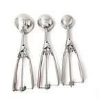 Set of stainless steel spring scoops with round bowls and scissor-style release levers