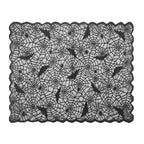 Black lace Halloween tablecloth with spider web pattern, bats, and spiders on orange-red gradient background.