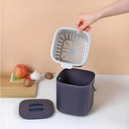 Navy countertop compost bin with open lid and removable inner vented tray