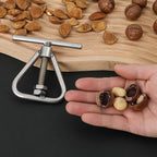 Stainless steel manual nutcracker and sheller with nuts and shells ready to crack