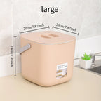 Large beige countertop food waste bin with hinged lid and side carry handle