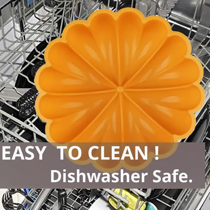 Orange pumpkin-shaped silicone cake pan in dishwasher rack, ridged design