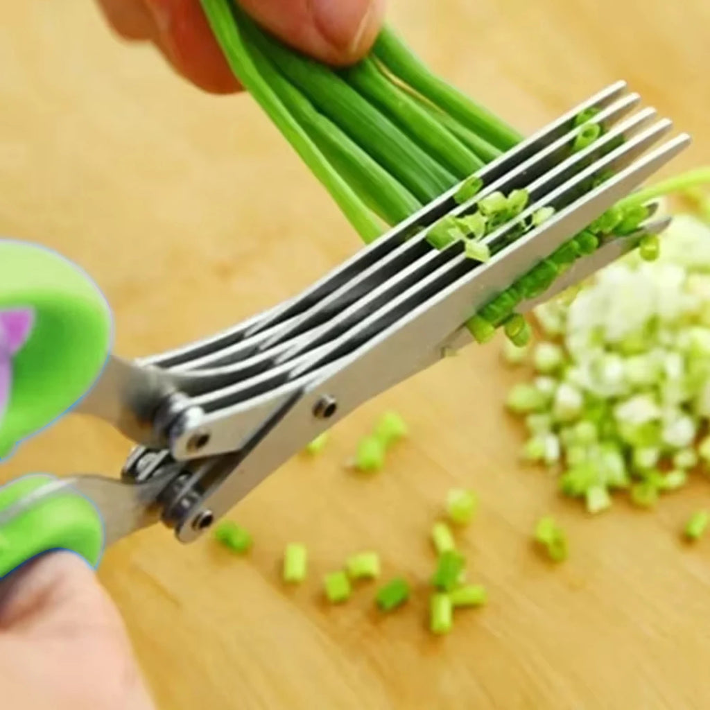 Close-up of stainless multi-blade herb shears with green handles cutting scallions