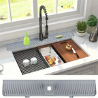Gray silicone sink splash guard and drain mat installed across the sink near faucet