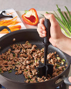 Black 5-blade meat chopper mashing meat in a skillet