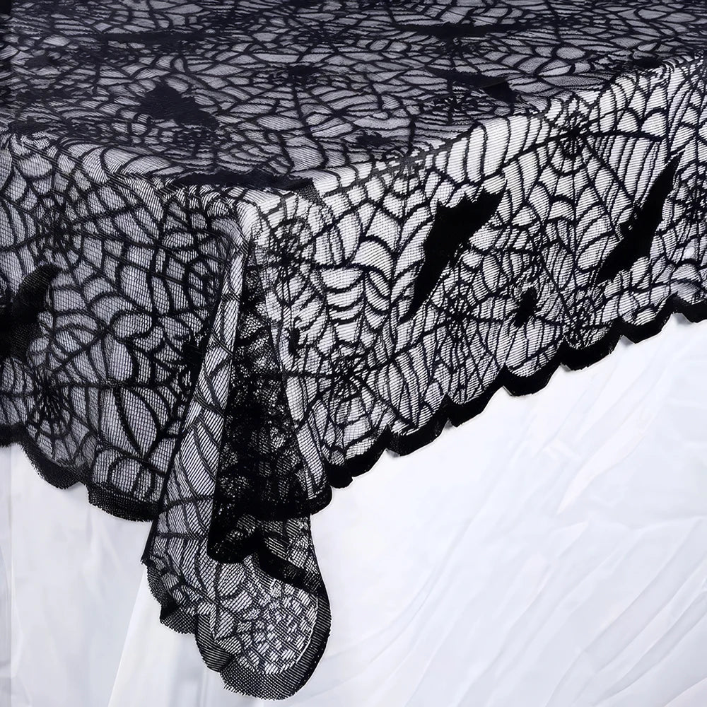 Black lace tablecloth draped corner with bat skull web pattern