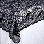 Black lace tablecloth corner with bat skull web pattern and scalloped edge