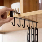 Under-cabinet 6-hook mug hanger in matte black, close-up with slide-on mounting bar
