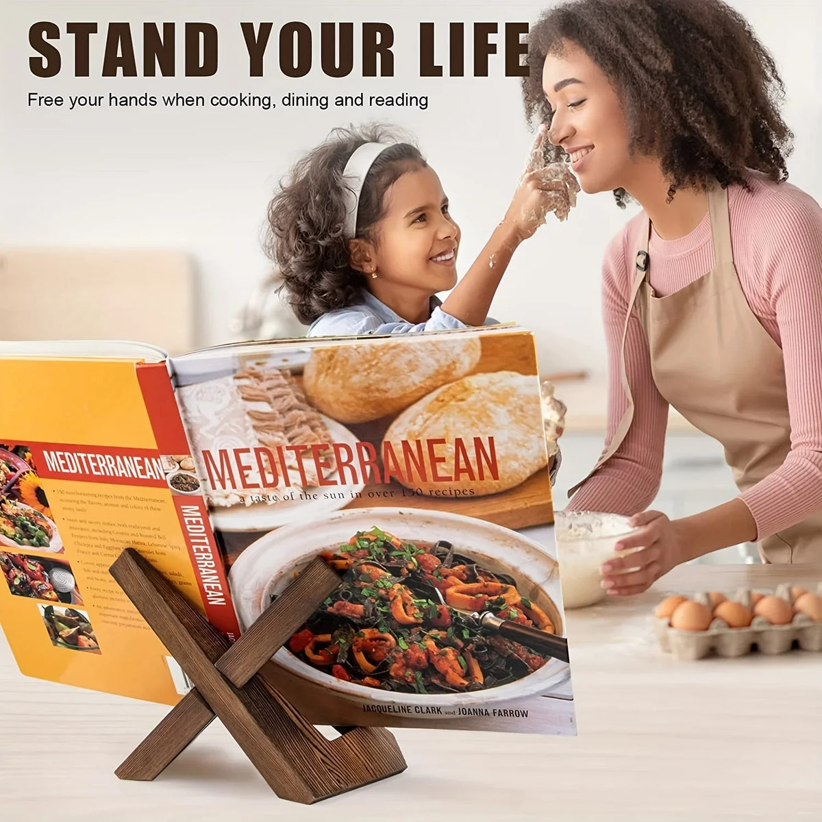 Wooden recipe stand with interlocking cross design supporting a cookbook on the table