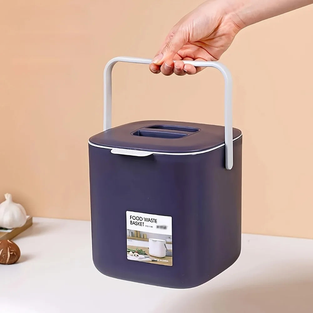Dark purple countertop food waste bin held by the side carry handle