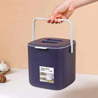 Dark purple countertop food waste bin held by the side carry handle