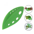 Green herb leaf stripper close-up with perforated 8-hole head and curved blade