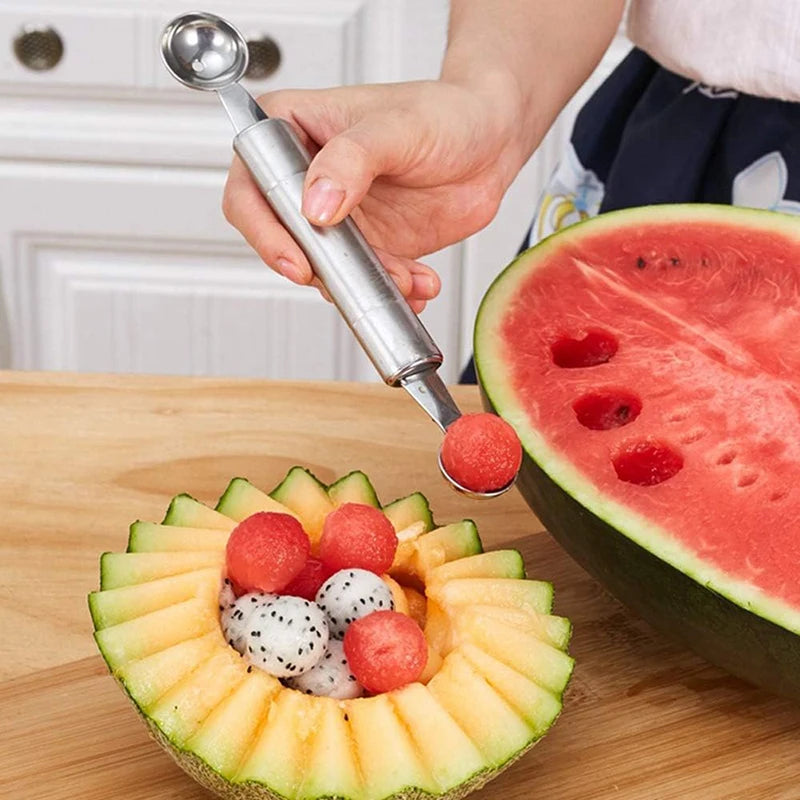 Stainless steel melon baller and carving tool with ball scoop end used on watermelon