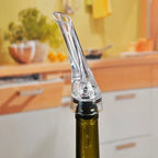 Wine aerator pourer spout inserted on bottle neck, clear aerator head with black ring