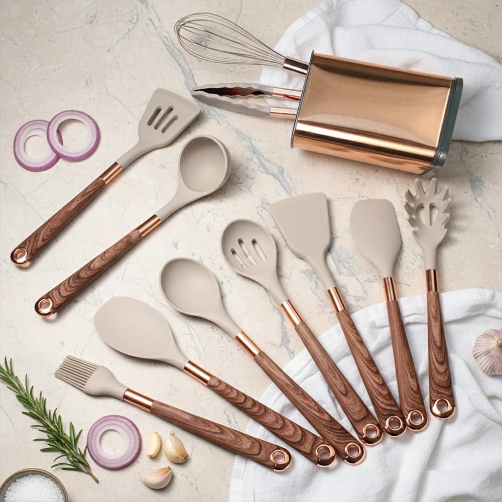Beige silicone cooking utensil set with rose-gold handles, whisk and spatula tools