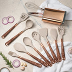 Beige silicone cooking utensil set with rose-gold handles, whisk and spatula tools