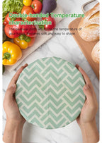 Mint green chevron reusable beeswax food wrap round sheet held by hands