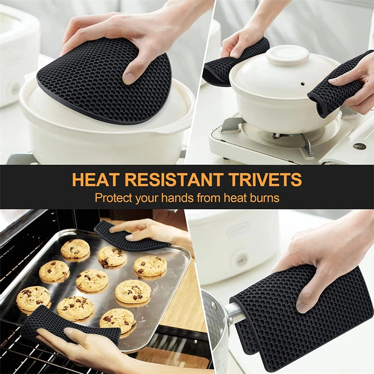 Black silicone trivets and hot pads with honeycomb texture beside cookware