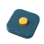 Blue square refrigerator deodorizer box with vent holes and yellow center button